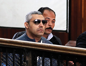 Mohamed Fahmy (in sunglasses) gets ready to speak in Cairo on Feb. 12, 2015, before a judge in court.