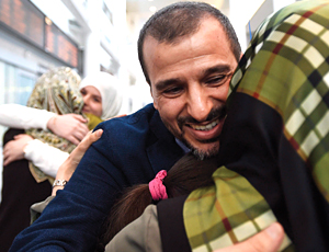 Salim Alaradi is greeted by family as he arrives at Pearson International Airport in Toronto on June 20, 2016.