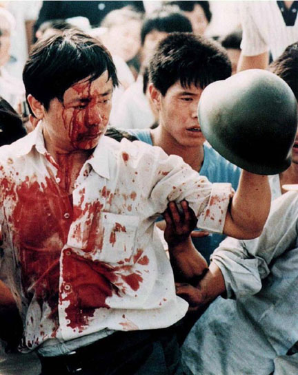 A blood-covered protester holds a Chinese soldier's helmet following violent clashes with military forces during the pro-democracy demonstrations in Tiananmen Square on June 4, 1989 (File photo: Reuters)