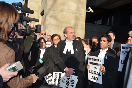 More than 100 Vancouver lawyers, including with Phil Rankin, centre, and Samiran Lakshman, representing the B.C. Crown Counsel Association, pinned blue ribbons to their robes to protest legal aid cuts. Photo: Jean Sorensen B.C. blue ribbon rally
